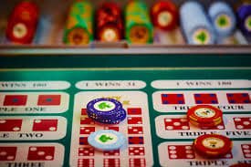 Mobile phone screen showing live baccarat betting interface with real-time player balance, card results, and betting buttons